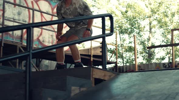 Millennial Roller Skater Jumping High Over Steps at City Skate Park alt