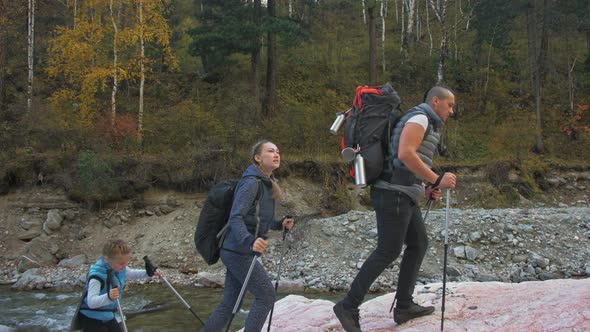 People Walk Near the Mountain River. Family Travels. People Environment By Mountains, Rivers alt