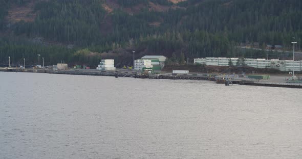 Aerial footage closeup behind Troopers helicopter flying across frame, exhaust over glaciers, rivers alt