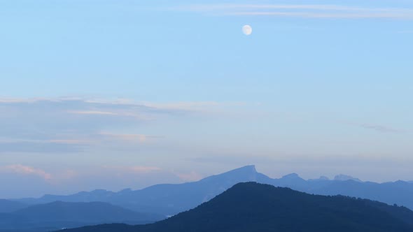 Time Lapse of Evening Mountain Landscape with Sky and Moon alt