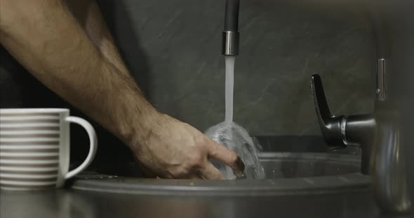 Closeup of the Process of Washing Dishes