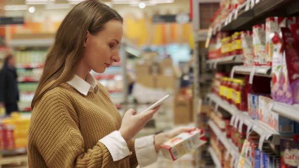 Woman Scans Information From the Barcode of a Tomato Jar Using Her Smartphone alt