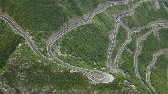 Сars Driving on Winding Serpentine Road in Deep Canyon
