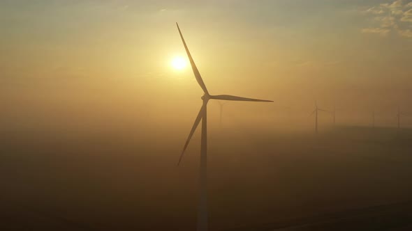 Windmills in Rotation at Fog Sunrise alt