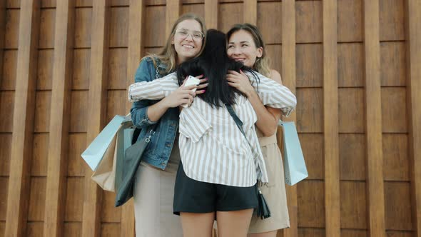Group of Women Meeting Outdoors Chatting Laughing Hugging Looking at Purchases in Shopping Bags alt