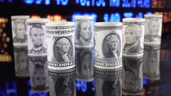 American Dollars Against The Background Of Stock Market Financial Data.