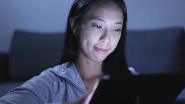 Woman Using Tablet Computer at Night 