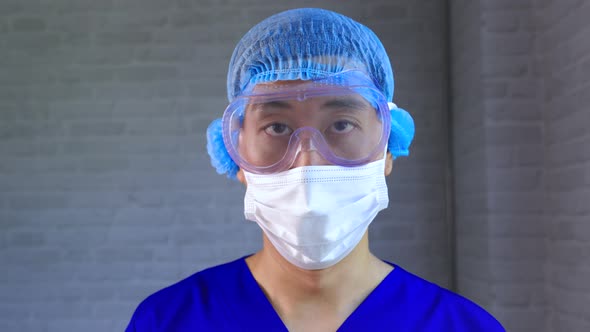 Male Worker Wear Protective Gears Like Latex Gloves Face Mask Bouffant Cap Medical Goggle at Work alt