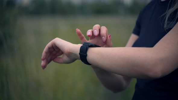 Fit Woman Jogging Checking Pace On Smart Watch. Run Girl Check Pulse On Fitness Bracelet. alt
