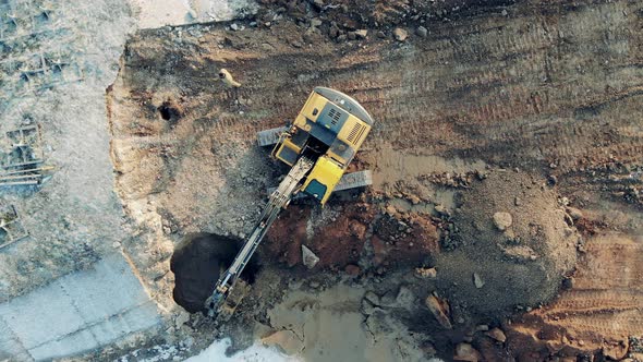 A Machine Digs Sand While Working at a Big Career. Construction Equipment, Heavy Industry Machinery. alt