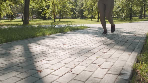 Low Section of Woman Jogging Outdoors alt