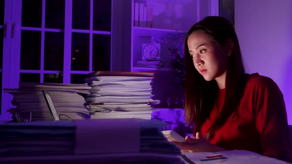 Workaholic people concept. Asian woman are overworked at night at home, late time business. alt