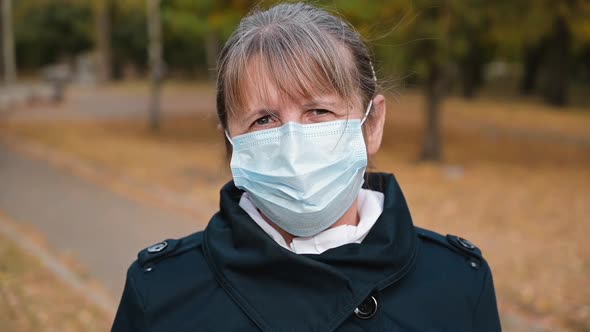 Portrait of a Senior Woman in a Respirator Protection Mask