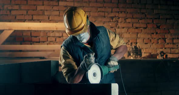 Male Builder in Respirator Cutting Wall alt