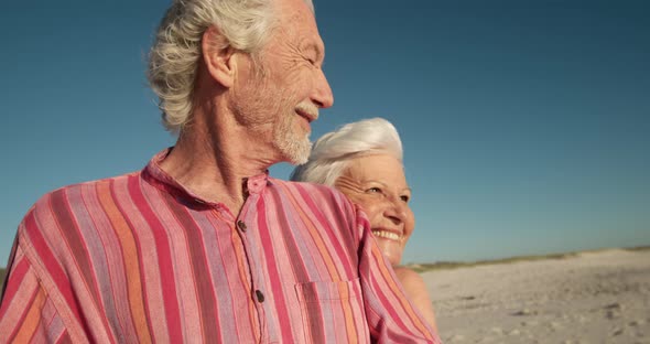 Senior couple enjoying free time at the beach alt