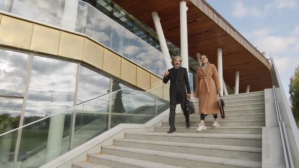 Business-Like Couple Leaving Office alt