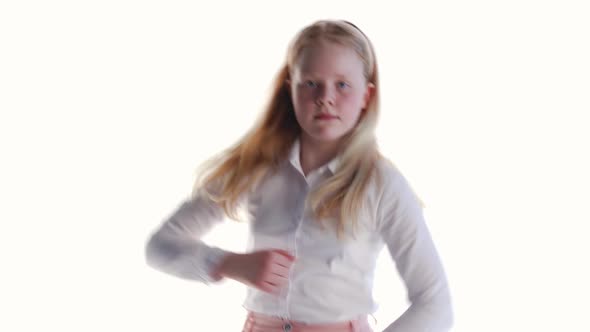 Cheerful Schoolgirl Girl on a White Background in the Studio Dancing Funny Dance