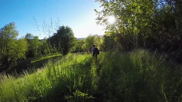 Following Backpacker Hiker Man Walking in Wild Woods alt