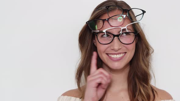 Model Trying on Many Eyeglasses at the Same Time