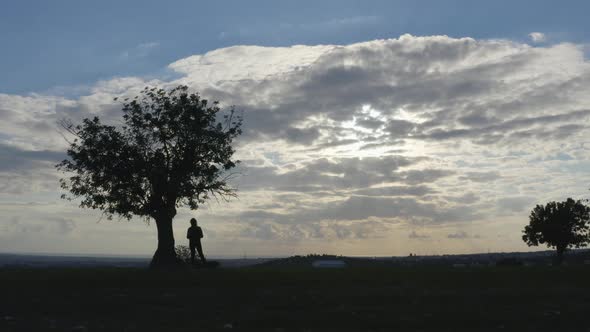 Aerial Shot of Female Silhouette in Nature Looking at Sky
