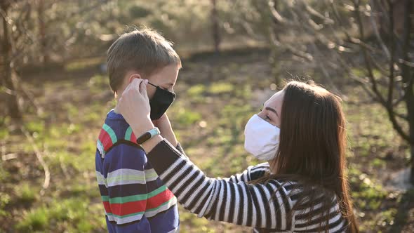 Caring Mother Puts Her Son on a Mask To Protect Against Viruses