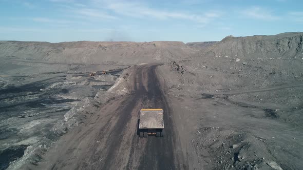 Camera Moves After Big Dump Truck Loaded to the Top with Coal