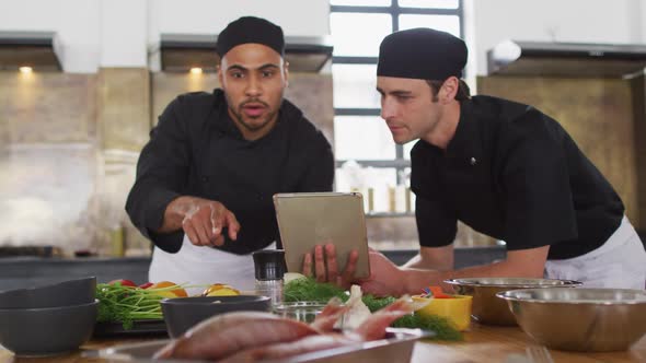 Diverse group of chefs preparing dishes and smiling alt