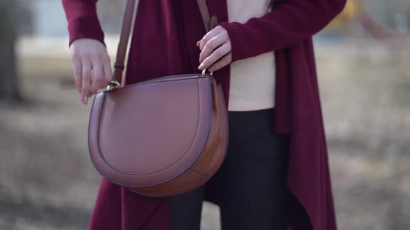 Woman Taking Protective Mask From Bag alt