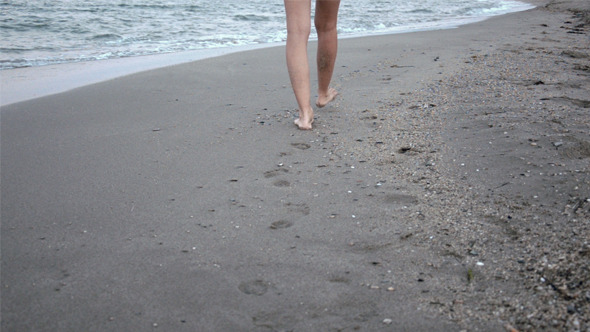 Woman Walking by the Sea