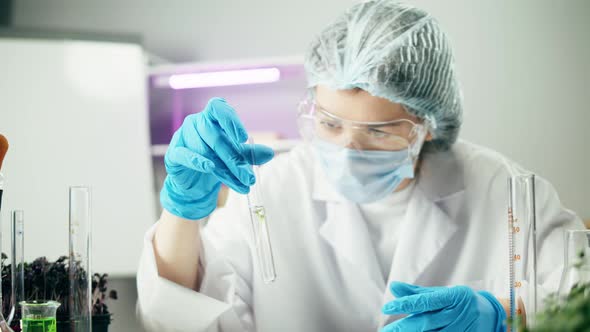 Medical Scientist Inspecting Minced Meat Wearing Protective Unform Working in Laboratory alt