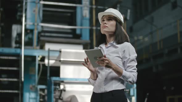 Executive Engineer Inspecting Factory Workshop alt