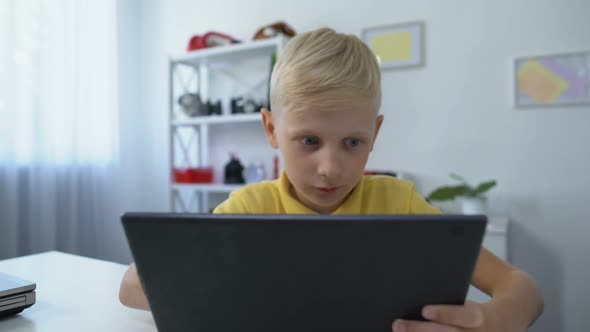 Little Boy Watching Movie on Tablet Pc at Home, Modern Technologies, Application