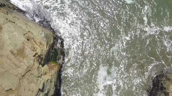 Slow motion from the cliffs to the bird rock in the water Wonderful aerial view flight slowly tilt u alt