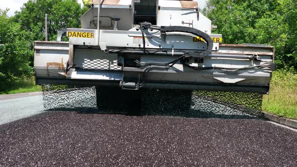 Heavy Machinery Resurfacing a Road Using Micro Asphalt Dressing alt