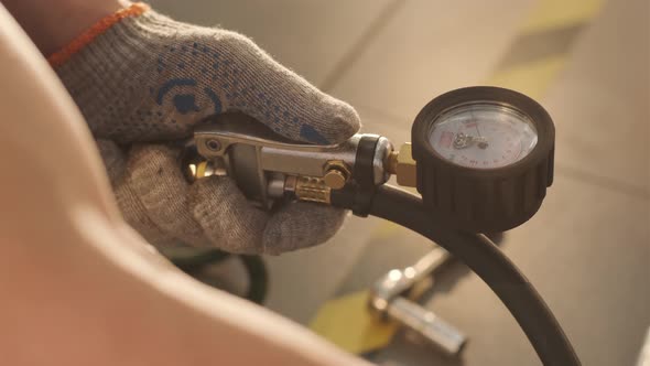 Filling the wheel with air from the compressor at the service station.  alt