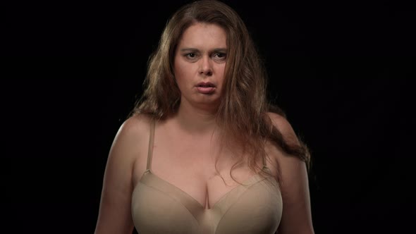 Portrait of Panicking Plus Size Woman in Underwear Looking at Camera Screaming Out Loud Covering alt