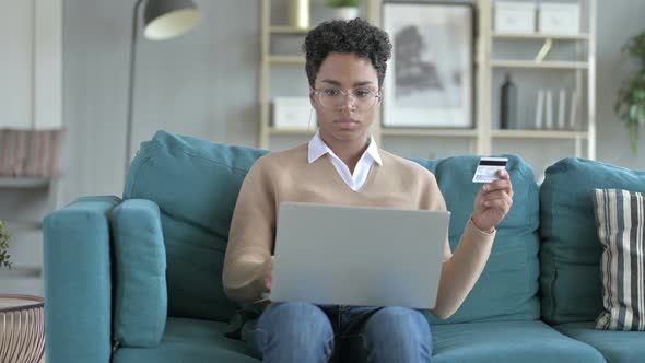 Young African Girl Trying To Use Credit Card Online alt