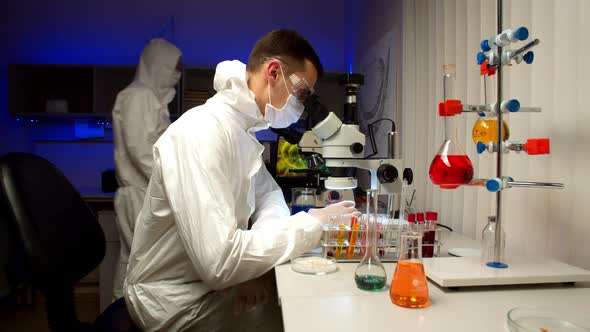 Scientist Examining Samples with Microscope