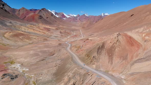 Drone View of Curved Road Crossing Hot Desert alt