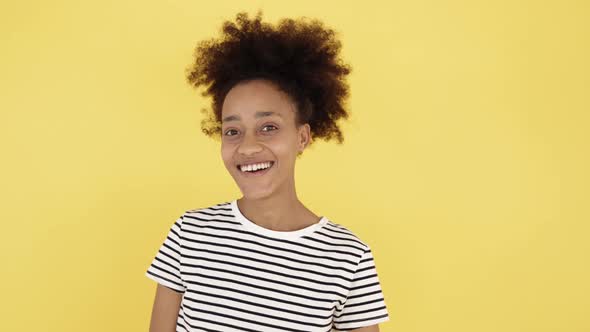 Front View Portrait of Smiling Young African Woman Laughing and Looking Camera alt