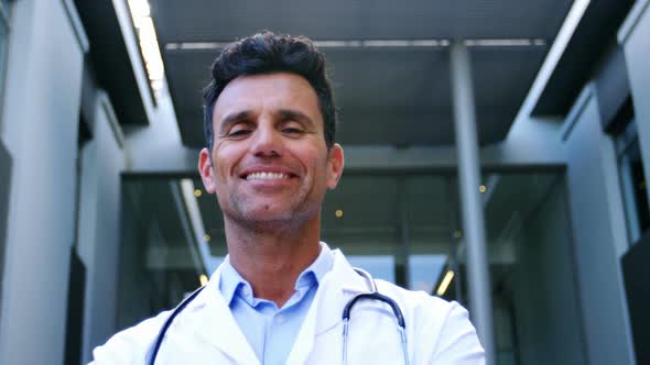Smiling doctor standing in hospital alt