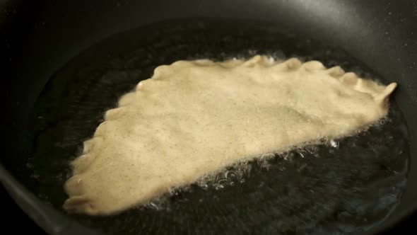 Process with Fried Homemade Chebureks or Qutab or Calzone with Minced Meat and Onion alt