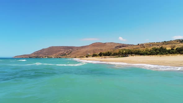 Drone Flying Low Above Water and Waves of Mediterranean Sea and Sand Beach alt