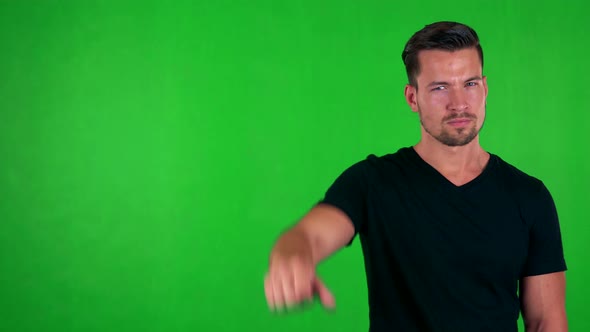 Young Handsome Caucasian Man Disagrees (Show Thumb Down) - Green Screen - Studio alt