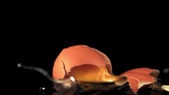 Super Slow Motion the Fresh Egg Falls on the Table and Breaks Down alt