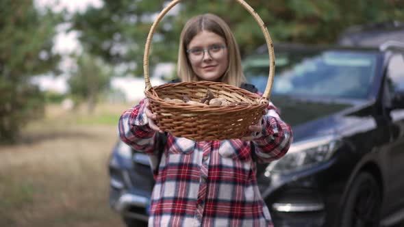 Front View Portrait of Confident Beautiful Woman Posing with Mushrooms in Forest Outdoors alt