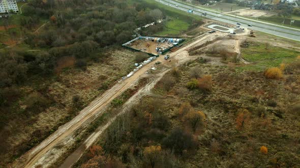 Construction site in a city vacant lot. Photographed in cloudy weather. Aerial photography. alt