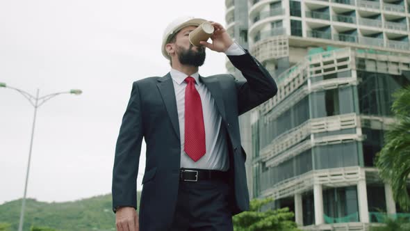 Potrait Senior Engineer Production Engineer at Work in a Business Suit Walking Around a Building alt