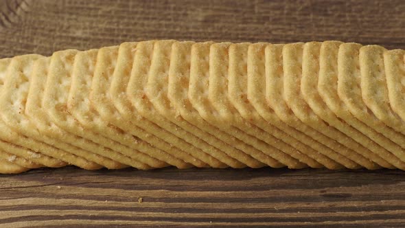 Tasty saltine crispy crackers on wooden background