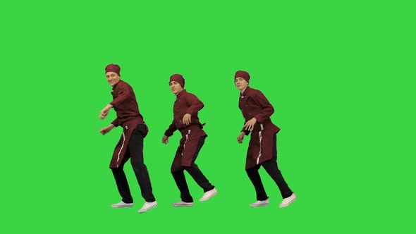 Three Smiling Chef Cooks in Red Uniform Synch Dancing Against Green Background and Pointing at alt